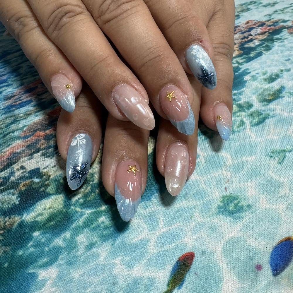 Ocean themed pearl blue nail art with starfish charms in Malta