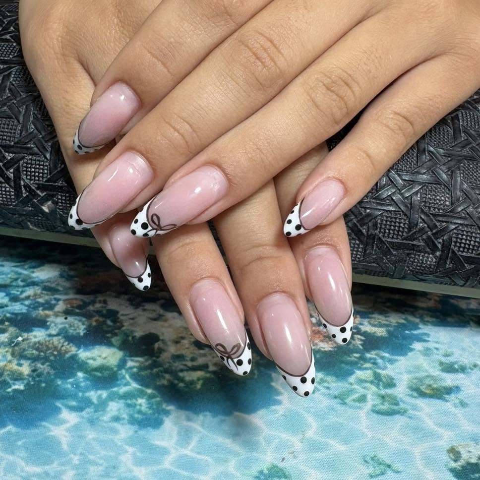 Polka dot French tip nails with bow design at Ta Bella Nail Salon